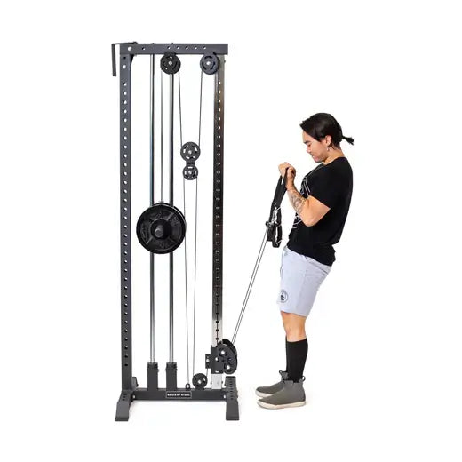 Person using Cable Tower plate-loaded fitness equipment for cable exercises in a home gym; compact and versatile gym machine in Vancouver.