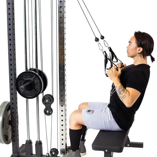 Person using Cable Tower (Plate Loaded) for exercises in a compact home gym setup.