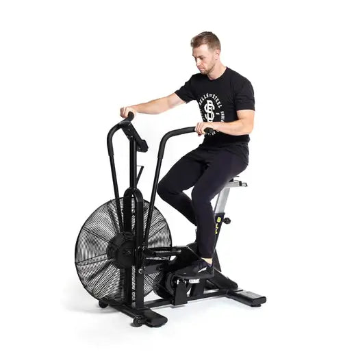 Man using Blitz Air Bike for cardio workout; exercise equipment available in Vancouver fitness stores.