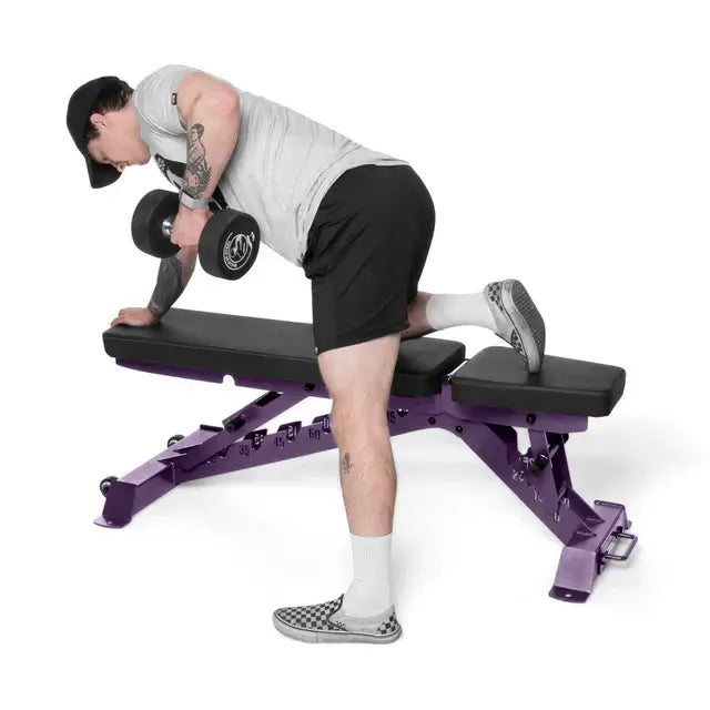 Man using BUZZ-SAW Heavy-Duty Adjustable Bench for weight training in Vancouver home gym.