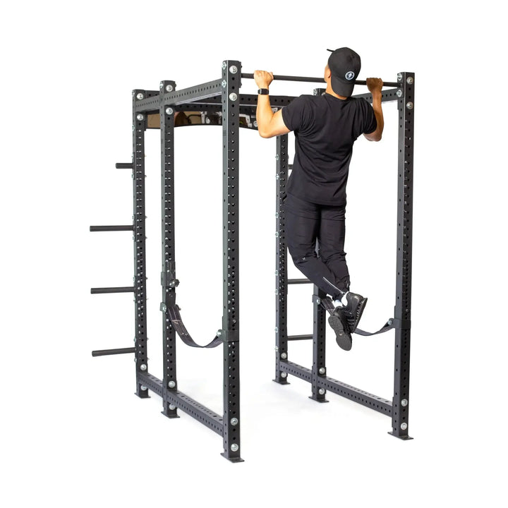 Hydra Six Post Power Rack in use with person doing pull-ups, fitness equipment Vancouver, ideal for home and commercial gyms.
