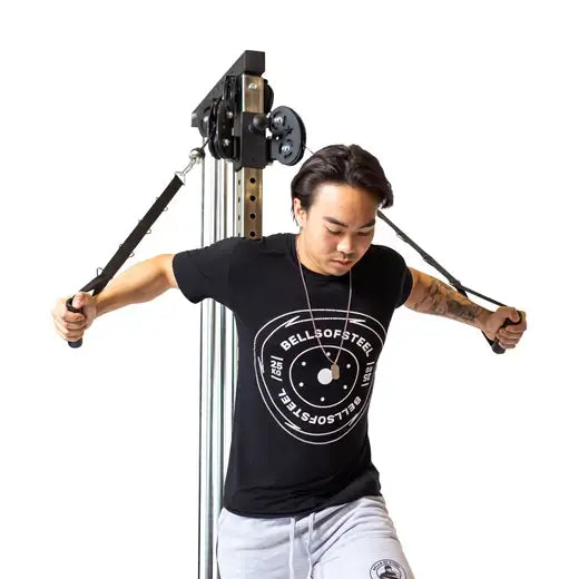 Person using a Cable Tower Plate Loaded gym machine for home workouts, ideal for small spaces and fitness equipment solutions in Vancouver.