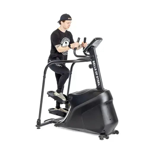 Person using a stair climber for cardio workout, fitness equipment available at Vancouver gym supply store.