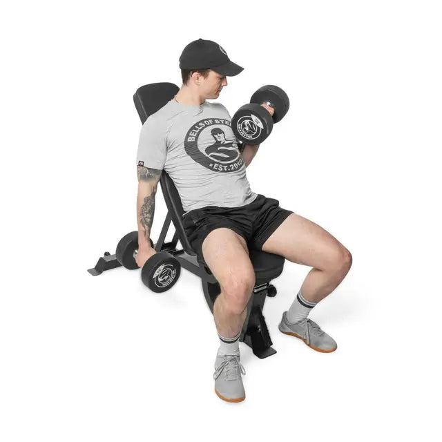 Man using adjustable utility bench with dumbbells, ideal for home gyms and fitness solutions in Vancouver.