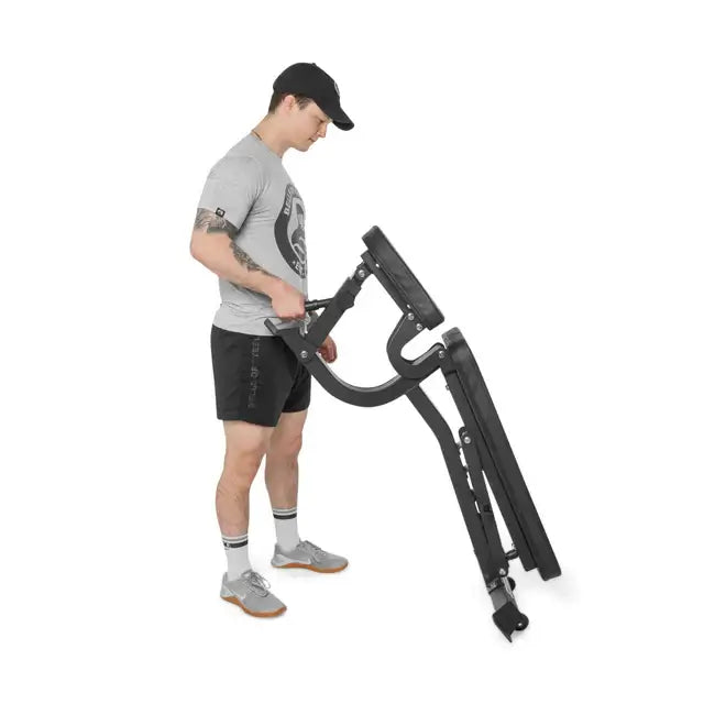 Person adjusting lightweight utility bench, ideal fitness equipment in Vancouver for home gym and exercise solutions.