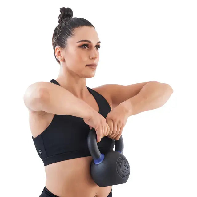 Woman exercising with powder-coated kettlebell, fitness equipment Vancouver.