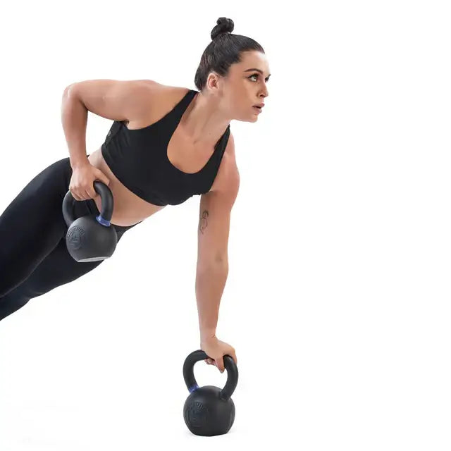 Woman using powder-coated kettlebells for workout, fitness equipment Vancouver