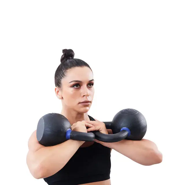 Woman using powder-coated kettlebells for fitness training in Vancouver gym equipment store