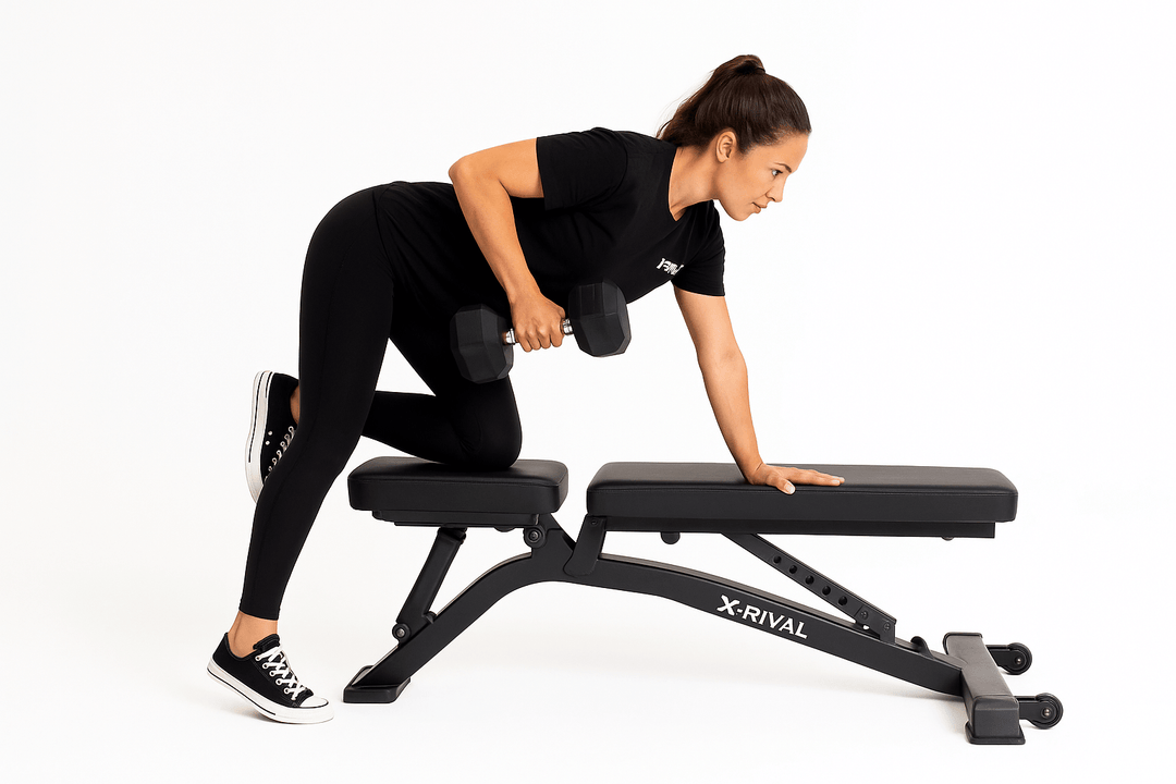 Woman performing row exercise with Rubber Hex Dumbbell on X-RIVAL bench, premium fitness equipment Vancouver.