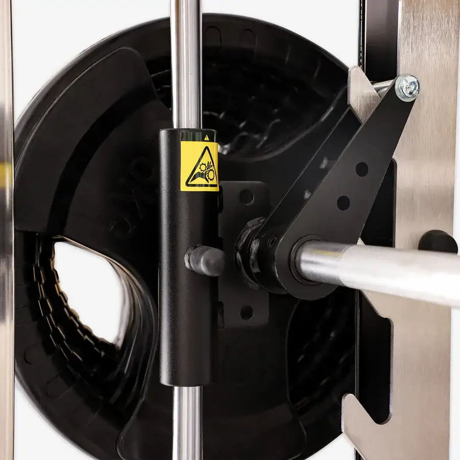 Close-up of Altas Strength Smith Machine AL-3061B in Vancouver gym, featuring weight stack and safety mechanism.