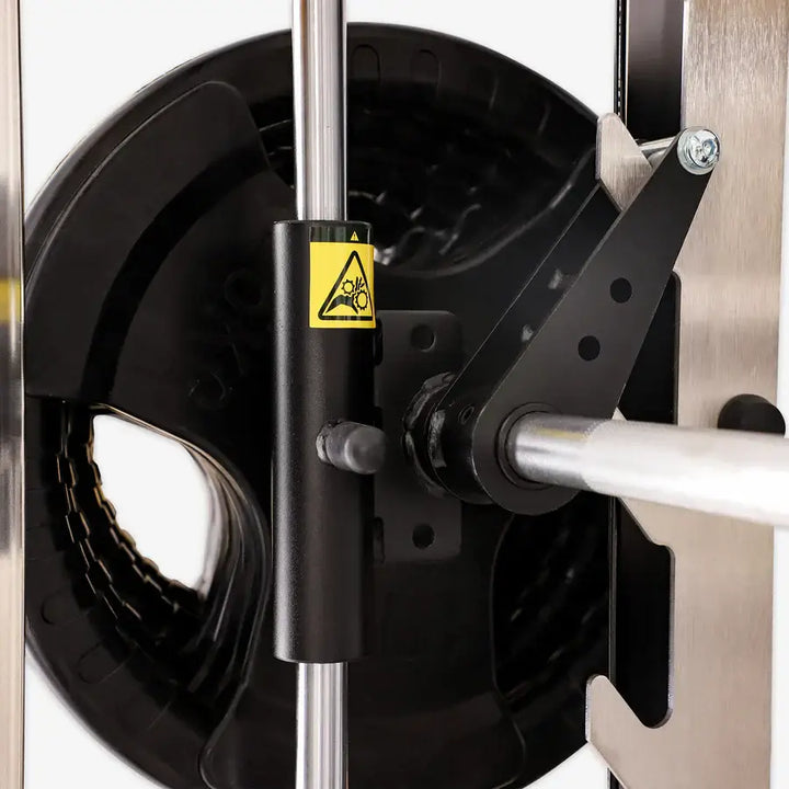 Close-up of Altas Strength Smith Machine AL-3061B in Vancouver gym, featuring weight stack and safety mechanism.